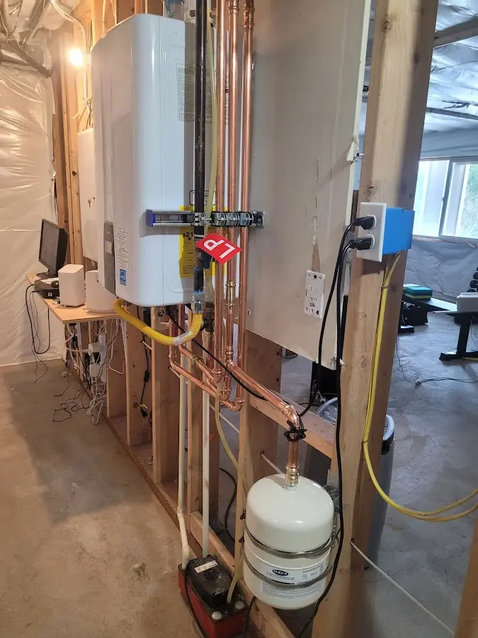 Licensed plumber repairing a kitchen sink in Millis
