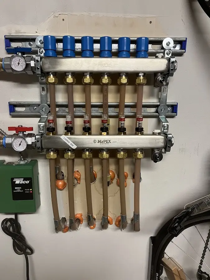 Plumber performing Water Heater Repair at a residential property in Millis